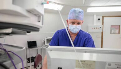 Consultant studying patient data on screen