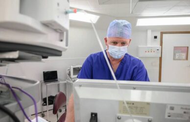 Consultant studying patient data on screen